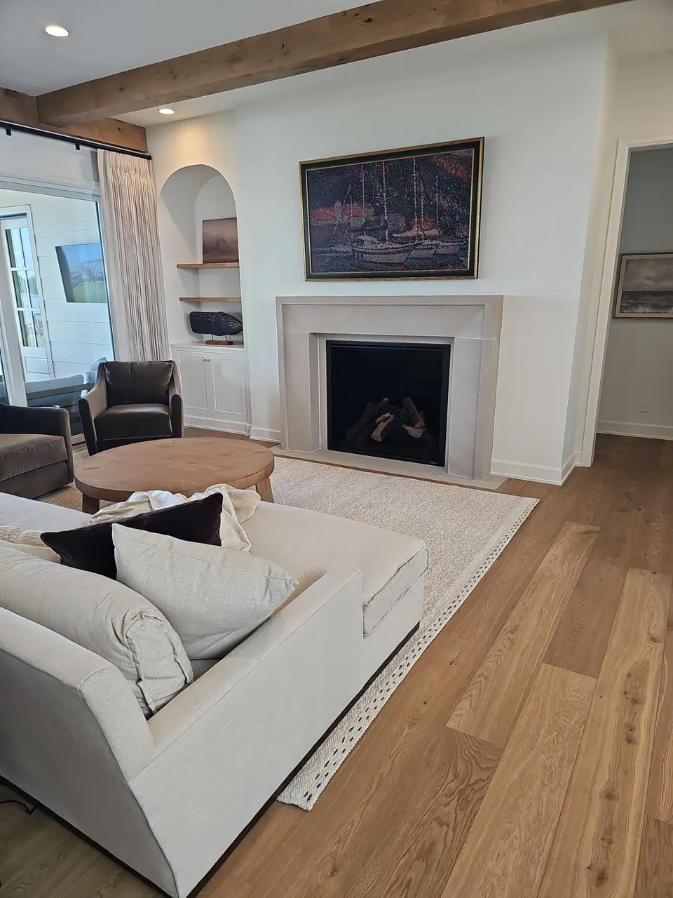 Living room with a fireplace and white walls, painted in interior season